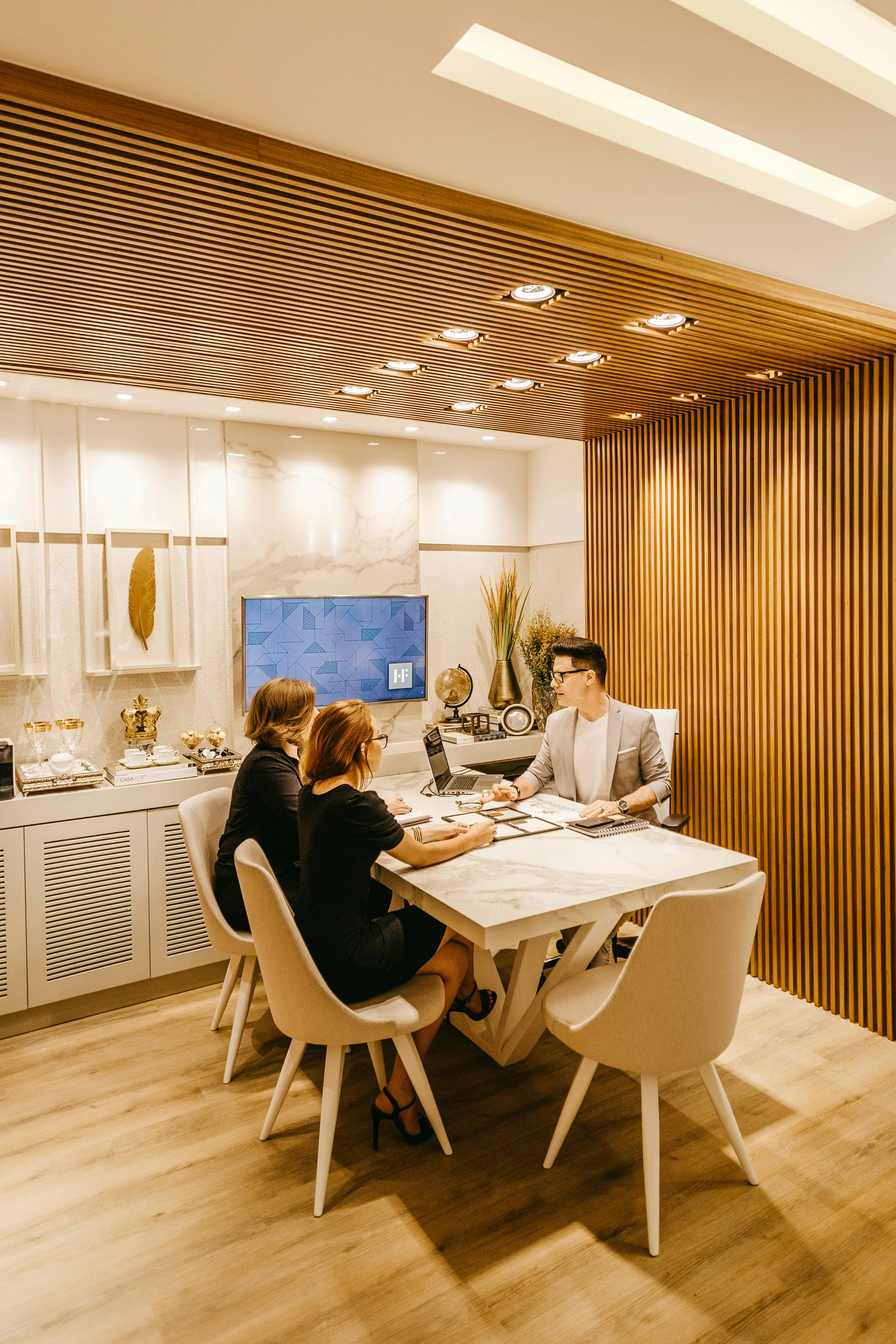 Advisers and clients reviewing a business acquisition